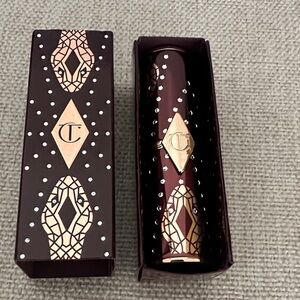 Charlotte Tilbury Deep Red Lipstick with Gold and Silver Accents